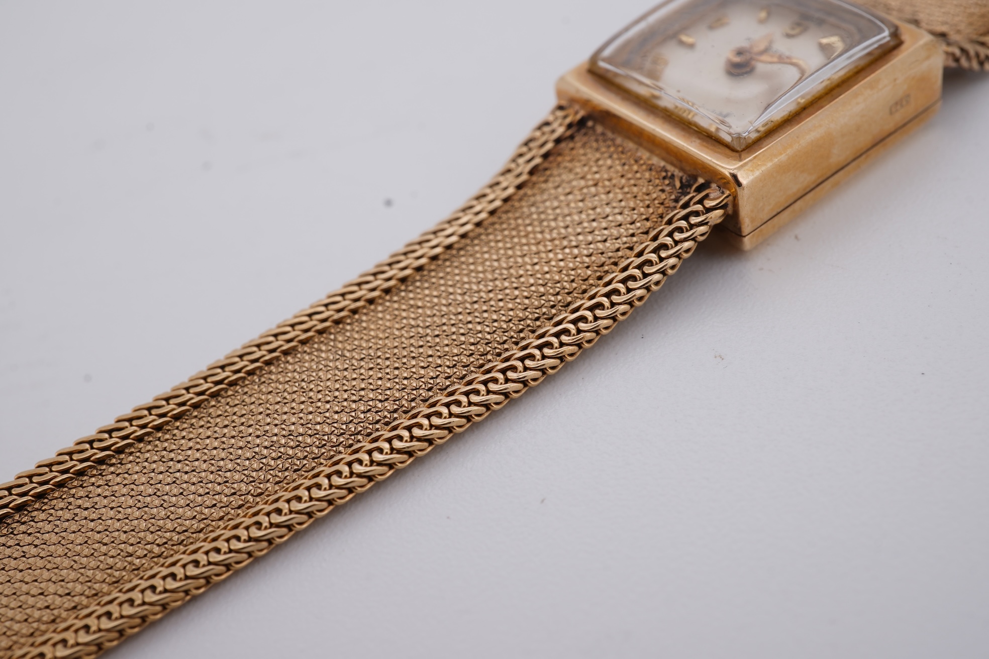 A lady's 1960's 9ct gold Rolex Precision manual wind wrist watch, with square dial, on an integral 9ct gold bracelet, the clasp with Rolex crown, overall length 15cm, gross weight 22 grams (bracelet a.f.)